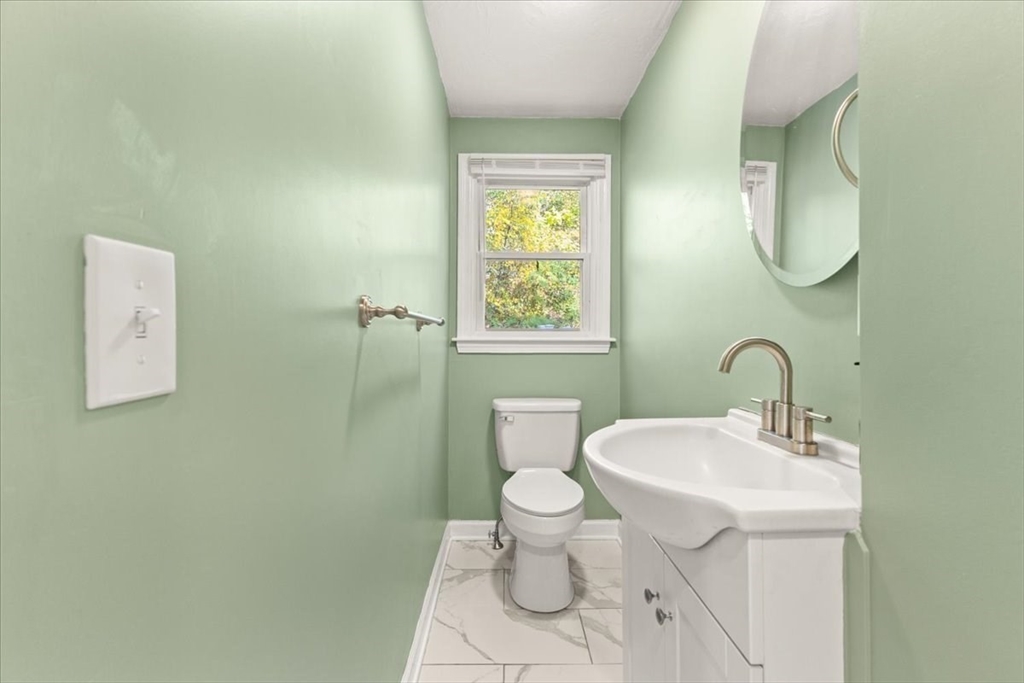 3 Federal Street, Unit 3 Blackstone, MA 01504 - Photo 14 of 27 a bathroom with a toilet sink and mirror