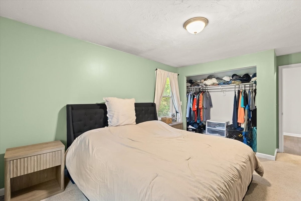 3 Federal Street, Unit 3 Blackstone, MA 01504 - Photo 22 of 27 a bedroom with a bed and a large mirror