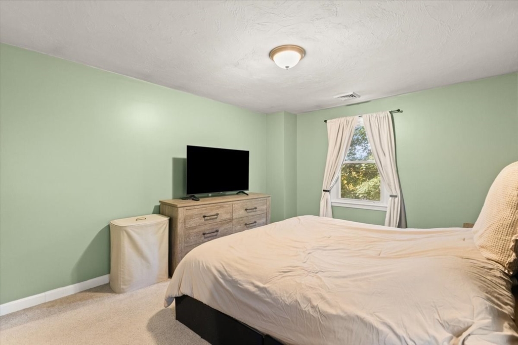 3 Federal Street, Unit 3 Blackstone, MA 01504 - Photo 23 of 27 a bedroom with a bed and a flat screen tv