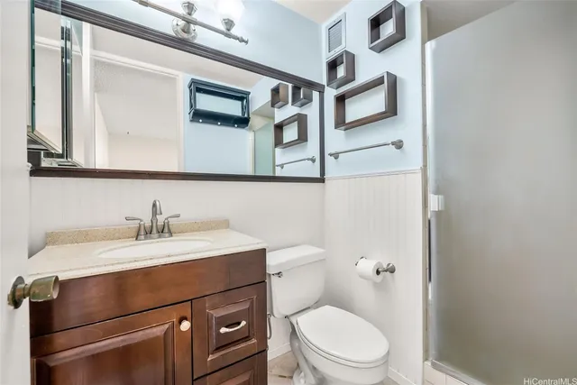 a bathroom with a sink a toilet and a mirror