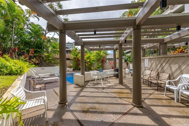 a view of patio with a table and chairs and potted plants