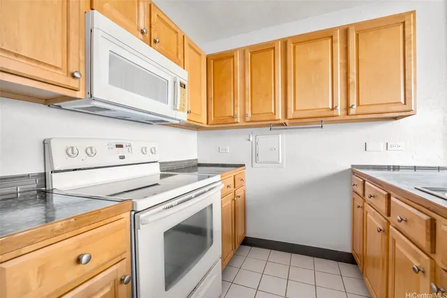 a kitchen with granite countertop cabinets stainless steel appliances and a sink