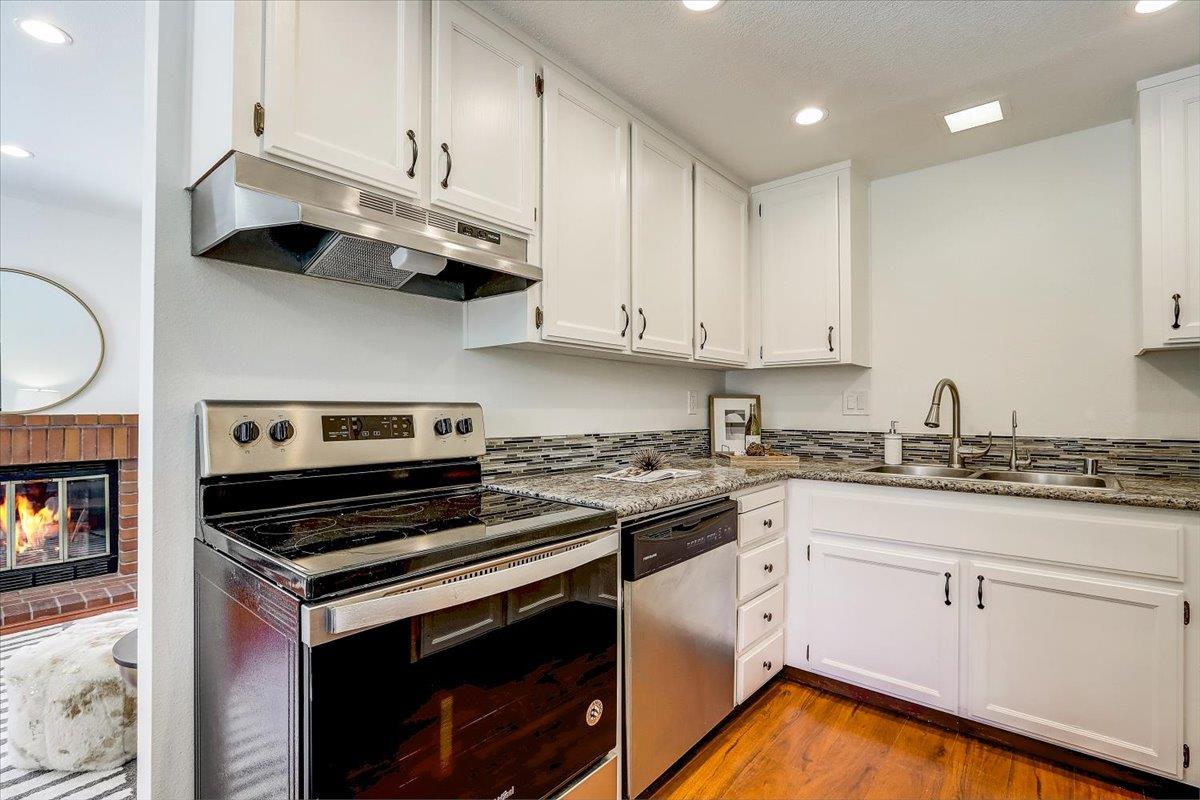 238 Mavis Drive Pleasanton, CA 94566 - Photo 16 of 53 a kitchen with stainless steel appliances granite countertop a stove and a white cabinets