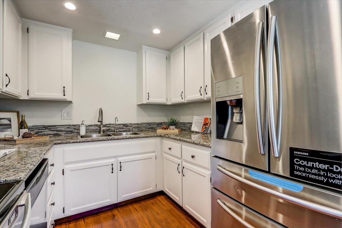 238 Mavis Drive Pleasanton, CA 94566 - Photo 17 of 53 a kitchen with granite countertop white cabinets and white appliances