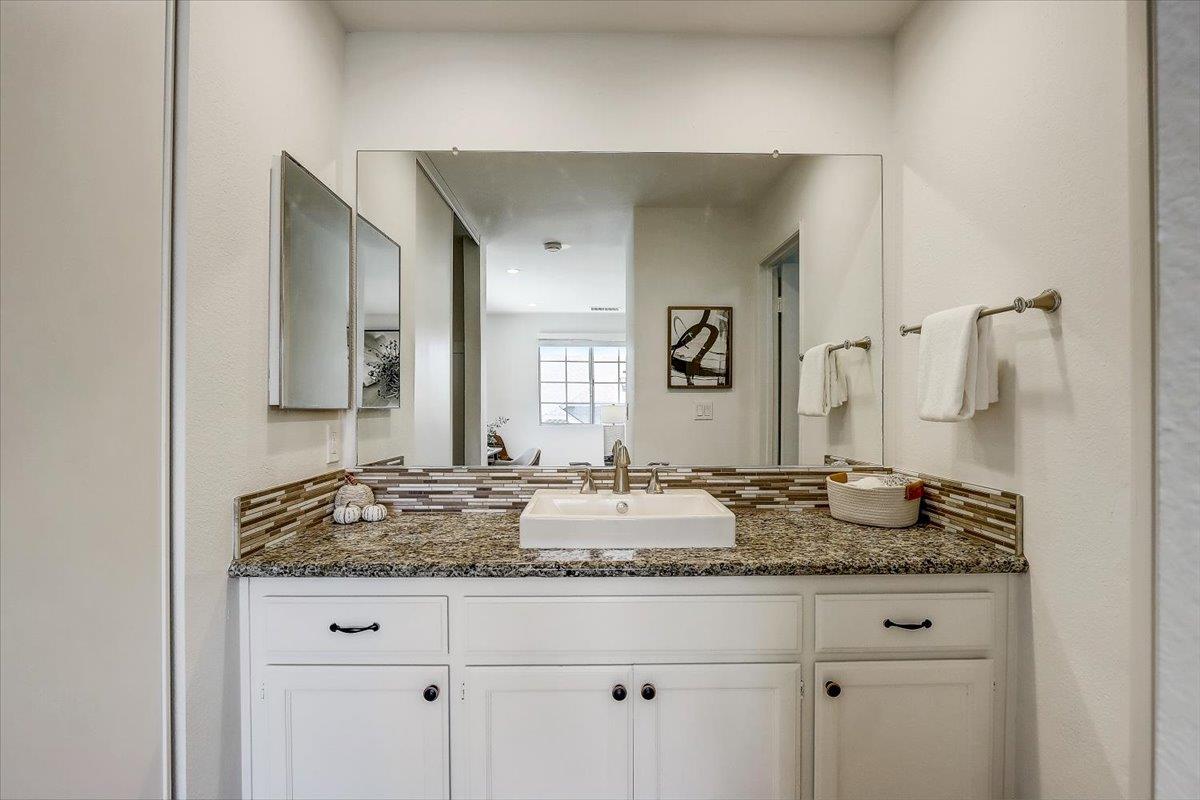 238 Mavis Drive Pleasanton, CA 94566 - Photo 20 of 53 a bathroom with a granite countertop sink and a mirror