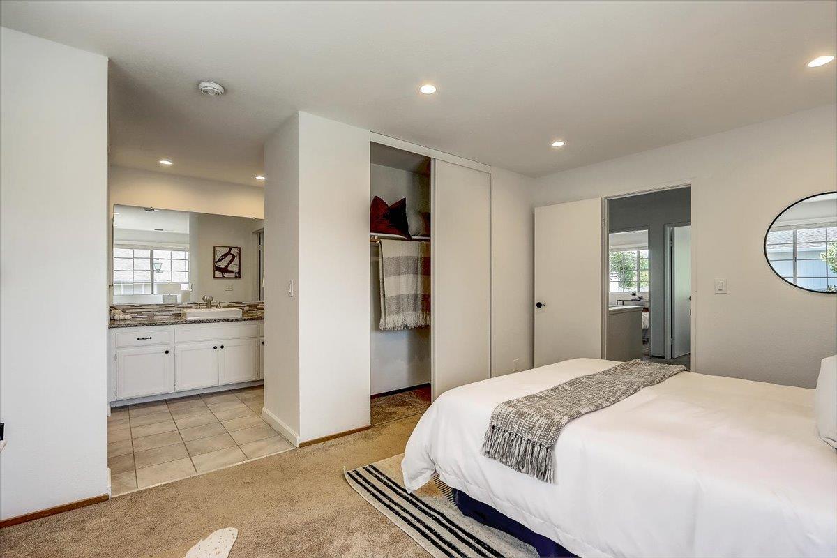 238 Mavis Drive Pleasanton, CA 94566 - Photo 22 of 53 a bedroom with a large bed and chandelier