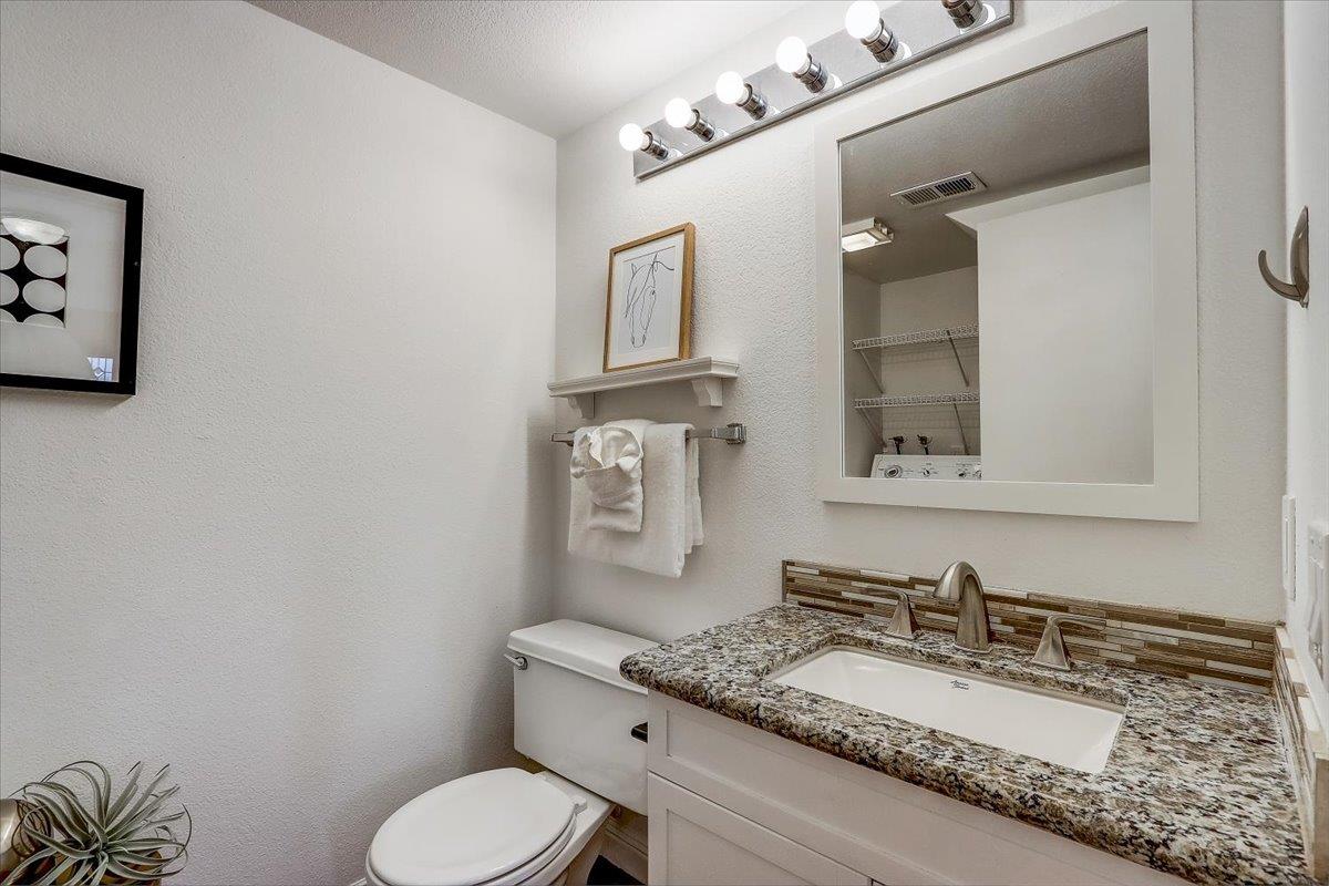 238 Mavis Drive Pleasanton, CA 94566 - Photo 26 of 53 a bathroom with a granite countertop toilet sink and mirror