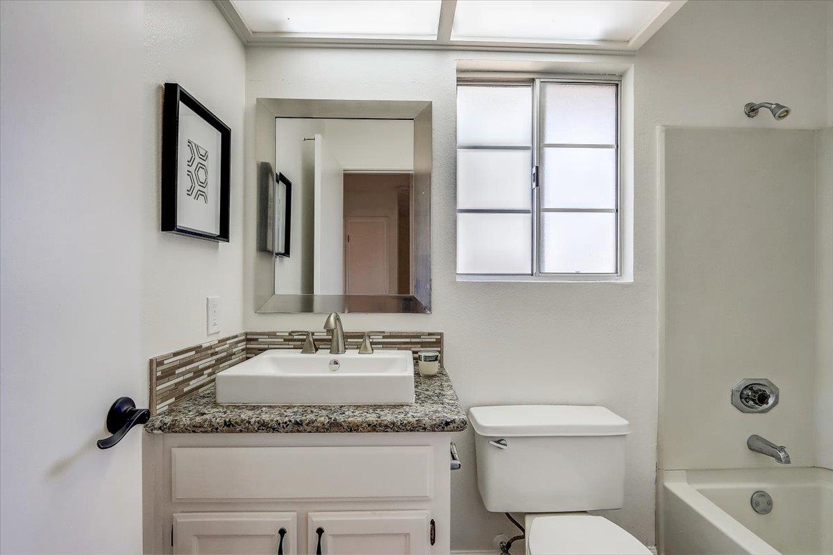238 Mavis Drive Pleasanton, CA 94566 - Photo 31 of 53 a bathroom with a granite countertop sink mirror vanity and toilet