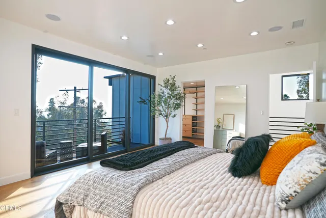 a bedroom with a large bed and a chandelier