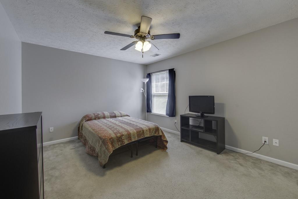 3973 Stephens Ridge Way Antioch, TN 37013 - Photo 18 of 19 a spacious bedroom with a bed and a flat screen tv