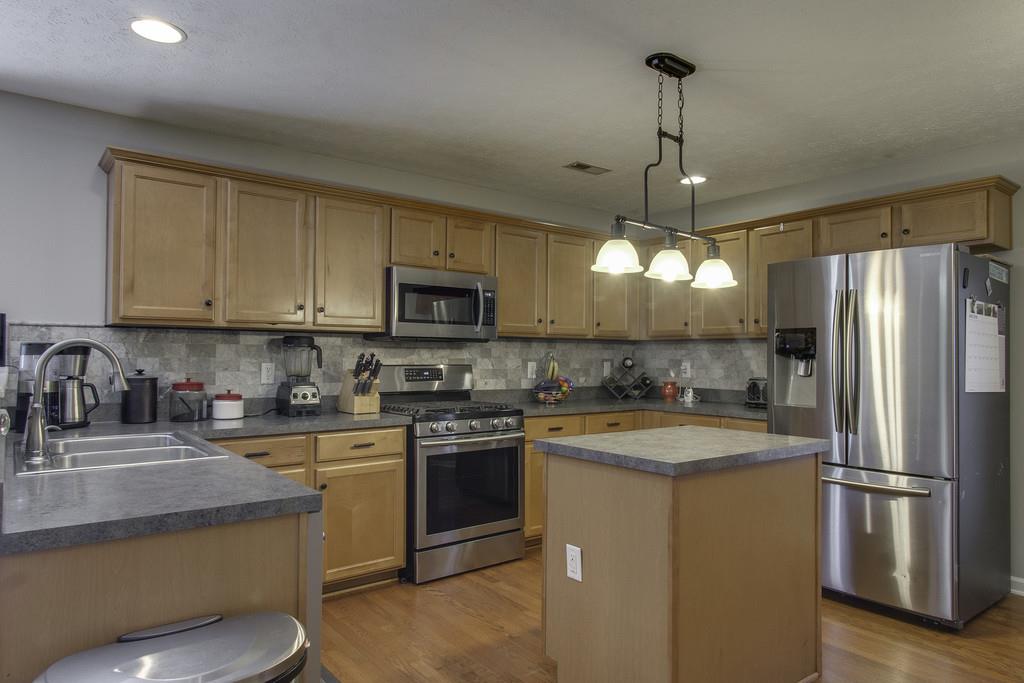 3973 Stephens Ridge Way Antioch, TN 37013 - Photo 9 of 19 a kitchen with stainless steel appliances granite countertop a stove a sink dishwasher a refrigerator and a microwave