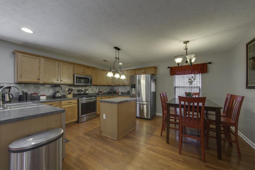 3973 Stephens Ridge Way Antioch, TN 37013 - Photo 10 of 19 a kitchen with a dining table chairs stainless steel appliances and cabinets