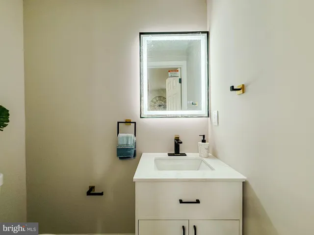 a bathroom with a sink and mirror