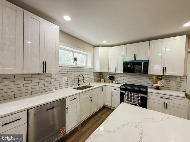 a kitchen with a sink stove and cabinets