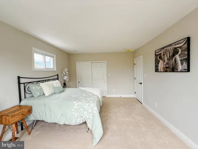 a bedroom with a bed and chair