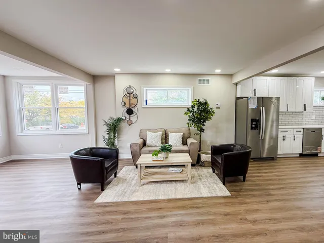 a living room with furniture fireplace and window