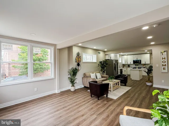 a living room with furniture and a potted plant