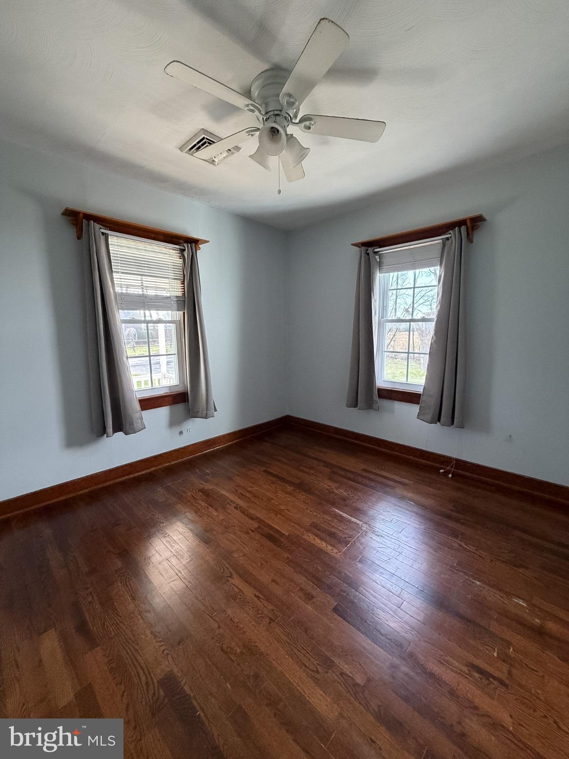 2929 Packer Street Winchester, VA 22601 - Photo 11 of 38 an empty room with wooden floor and windows