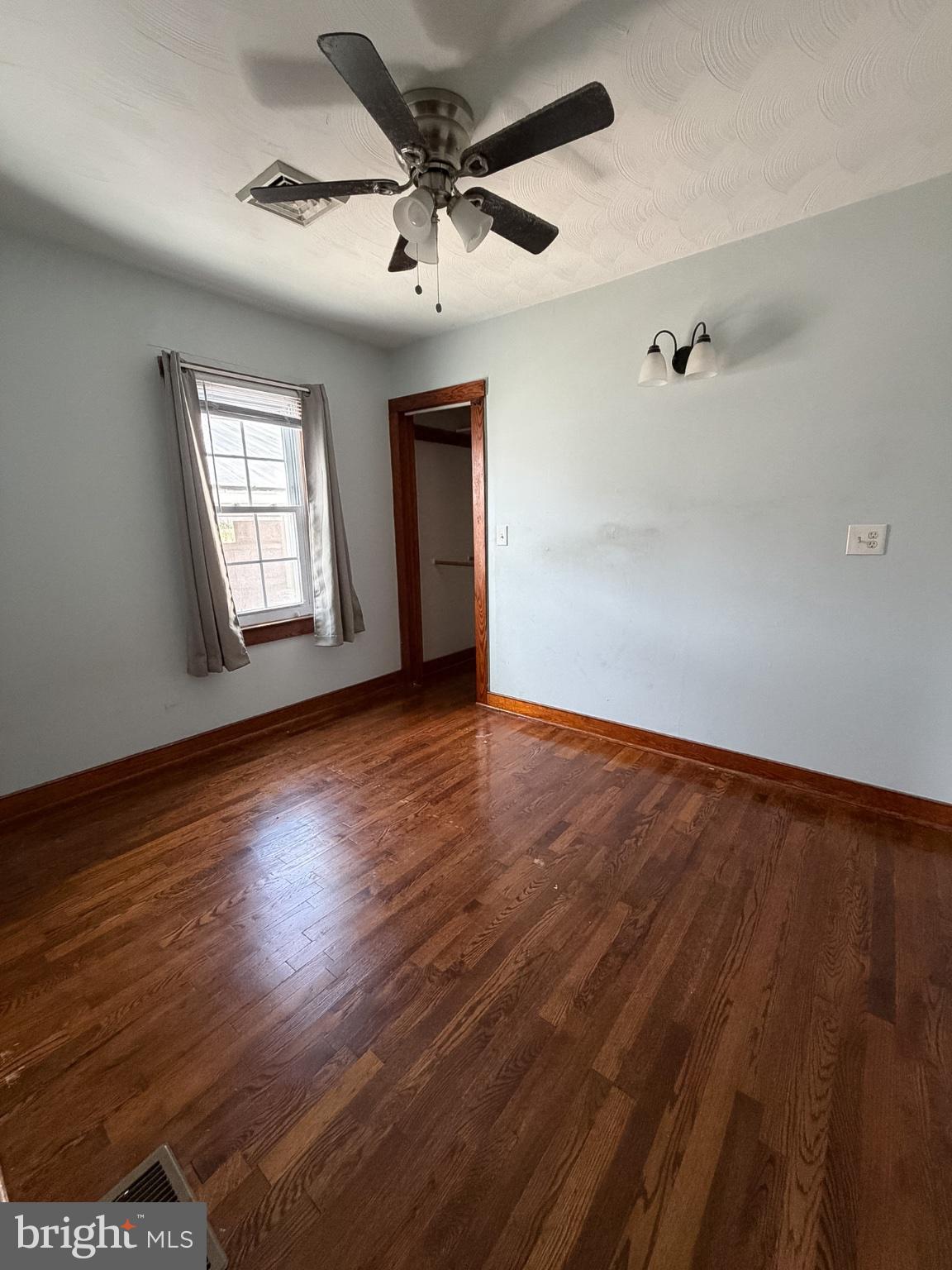 2929 Packer Street Winchester, VA 22601 - Photo 14 of 38 an empty room with wooden floor chandelier fan and windows