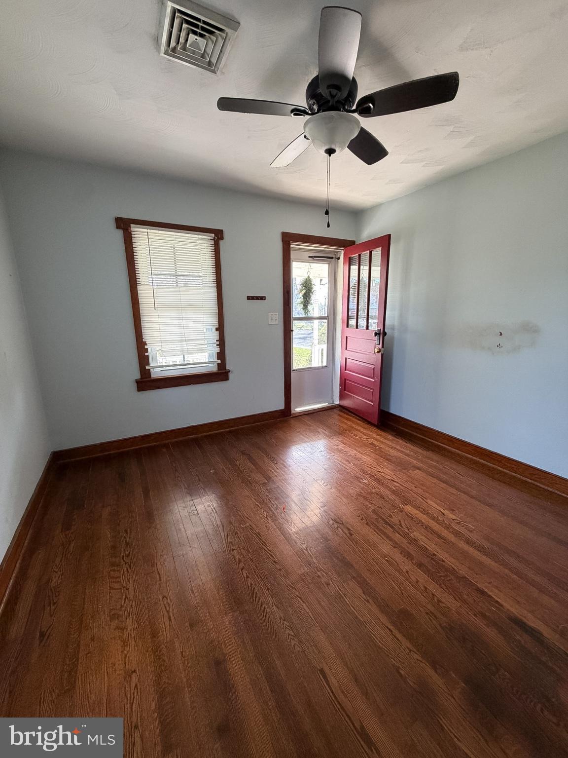 2929 Packer Street Winchester, VA 22601 - Photo 6 of 38 a view of an empty room with wooden floor and a window