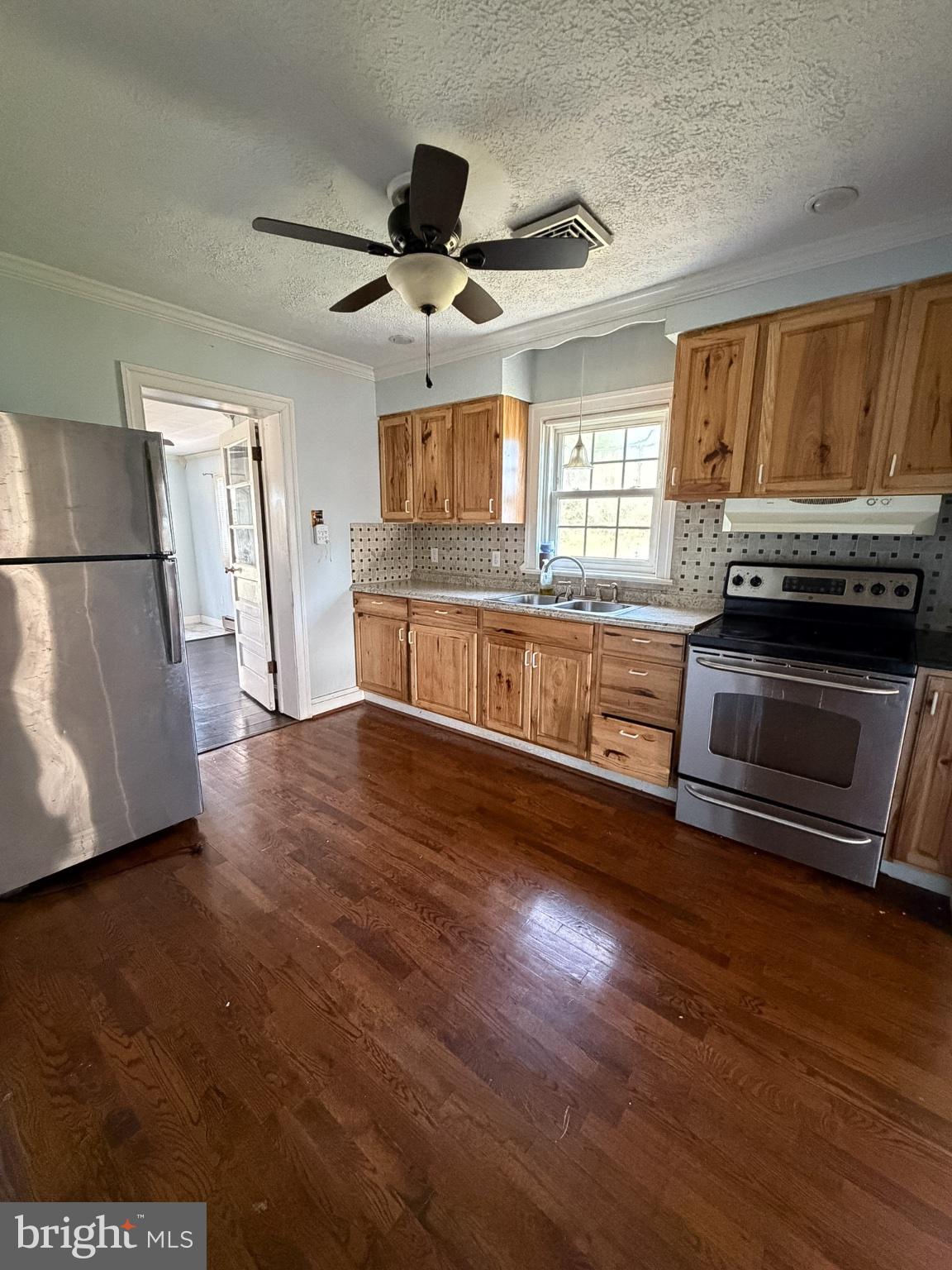 2929 Packer Street Winchester, VA 22601 - Photo 9 of 38 a large kitchen with cabinets wooden floor and stainless steel appliances