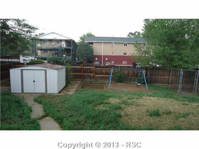 1040 Rice Drive Colorado Springs, CO 80905 - Photo 12 of 12 Shed, Swingset, Dog run in back yard