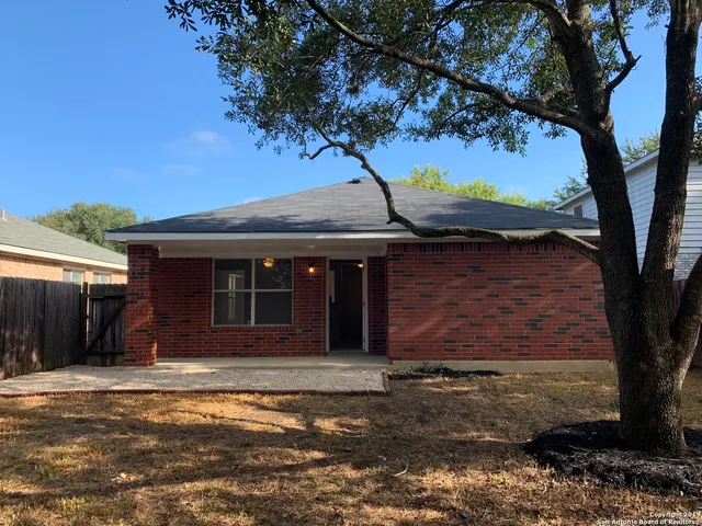 a kitchen with a refrigerator and a stove top oven