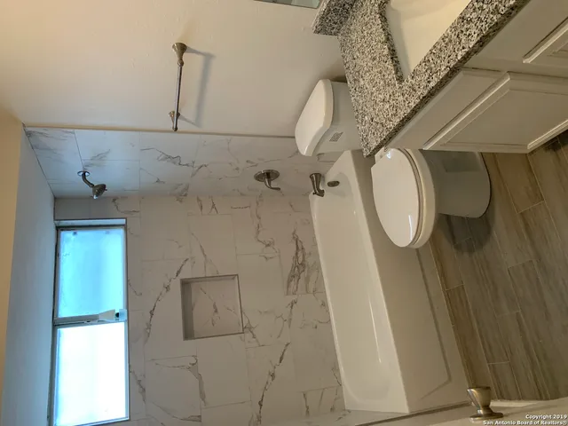 a front view of a house with a tree