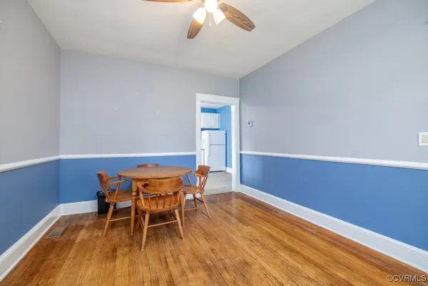 a dining room with furniture and wooden floor