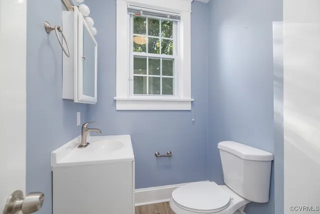 a white toilet sitting next to a bathroom sink
