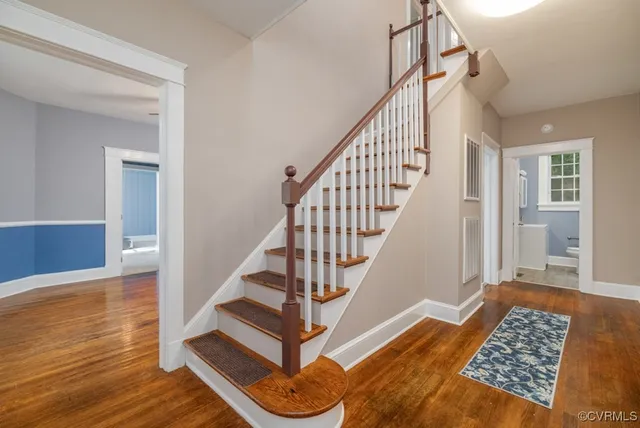 a view of entryway and hall with wooden floor
