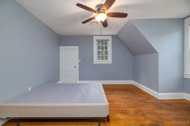 a bedroom with a bed and a ceiling fan