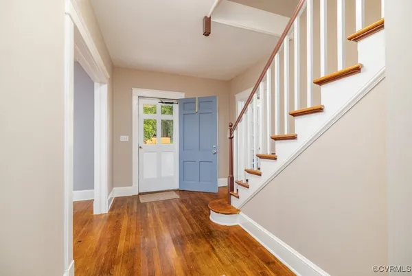a view of entryway with wooden floor and stairs