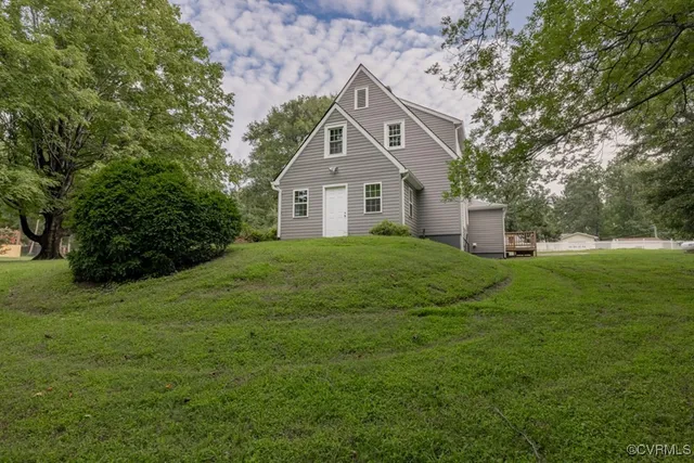 a front view of a house with a yard and trees