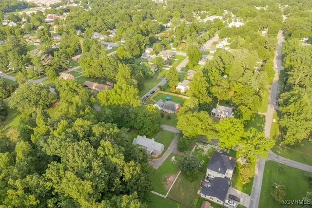 an aerial view of a house with a yard