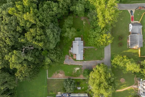 an aerial view of a house with a yard