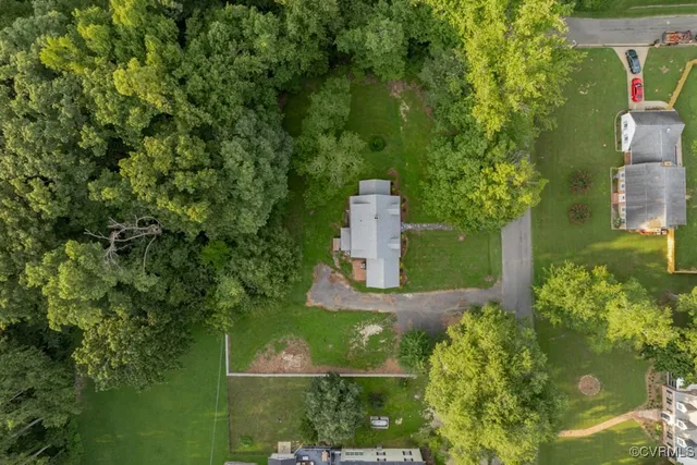an aerial view of a house with a yard
