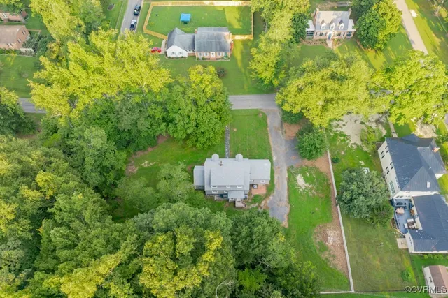 an aerial view of a house with a yard
