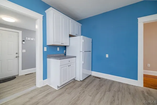 a kitchen with granite countertop white cabinets and stainless steel appliances