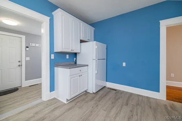 a kitchen with granite countertop white cabinets and stainless steel appliances