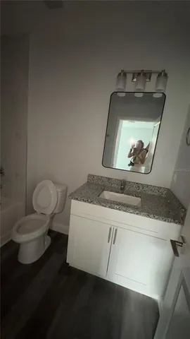a view of a living room a stove and wooden floor