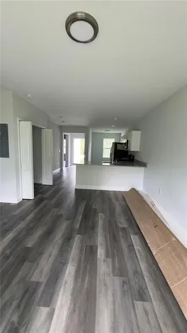 a view of a room with wooden floor and window
