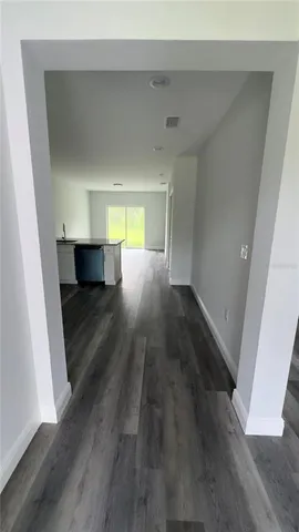 a view of a hallway with wooden floor