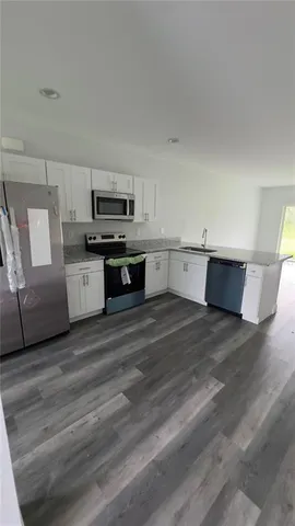 a view of a kitchen with a sink cabinets and a window