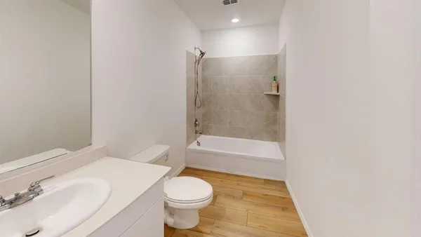 a bathroom with a toilet and a bath tub