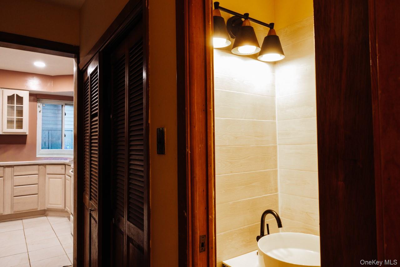 1322 Barry Drive South Valley Stream, NY 11580 - Photo 3 of 12 a bathroom with a sink and a mirror