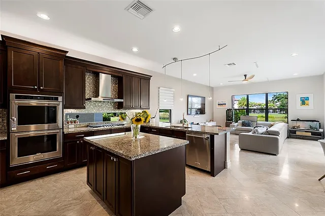 a kitchen with sink a counter top space appliances and cabinets