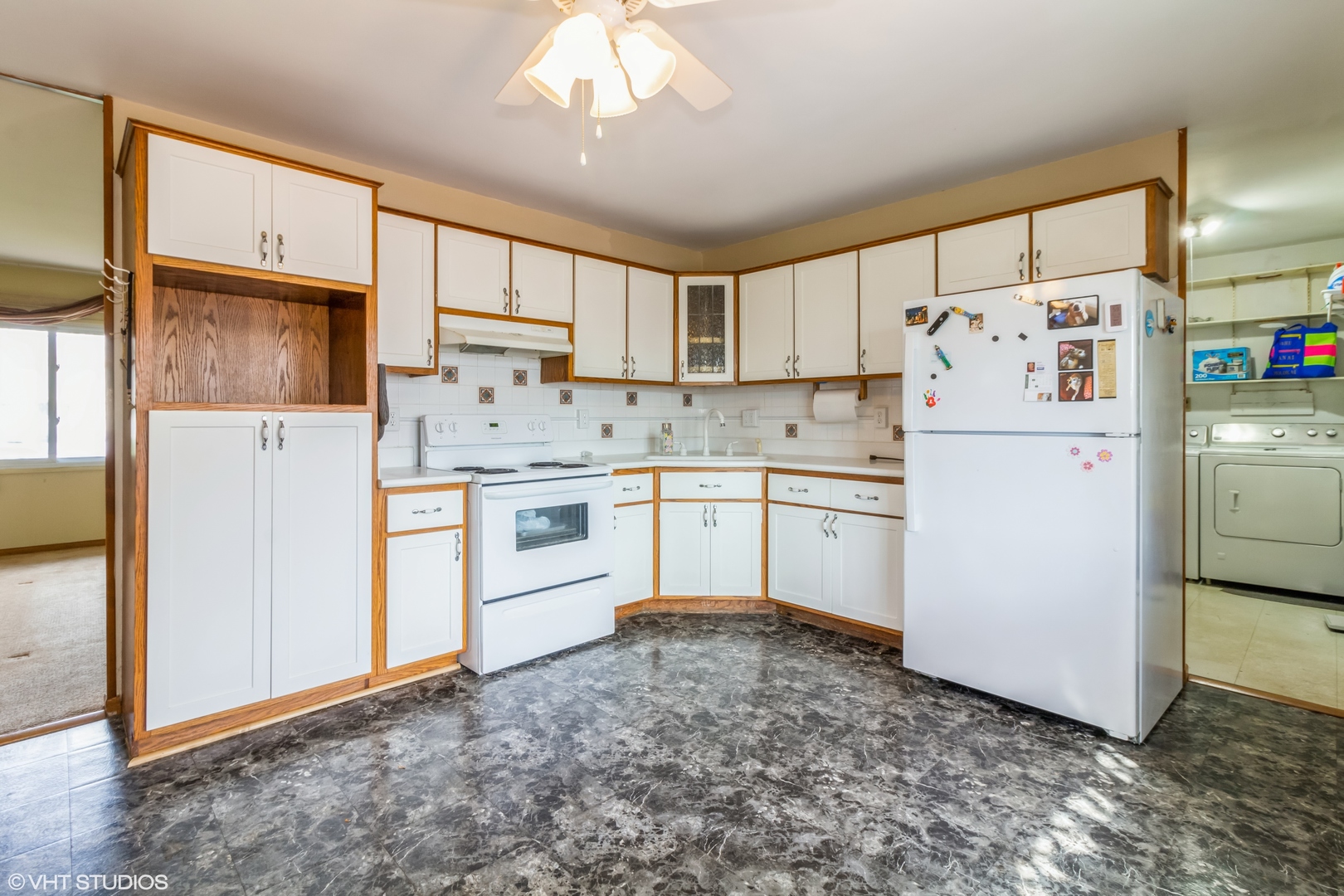 805 Cypress Lane Joliet, IL 60435 - Photo 3 of 10 a kitchen with a refrigerator a stove top oven cabinets and a dining table