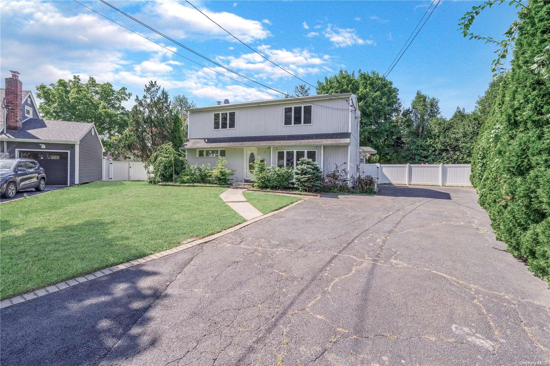 a view of a house with a yard and potted plants