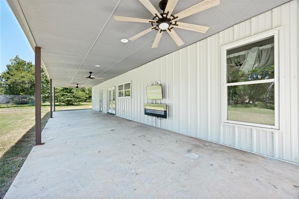 822 Private Road 7370 Point, TX 75472 - Photo 17 of 30 Expansive covered patio featuring a concrete surface and a white metal exterior wall